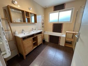 a bathroom with a sink and a tub and a window at La Roselière - CDDT in Yves +31 photos