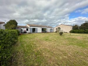 a house with a large yard in front of it at La Roselière - CDDT in Yves