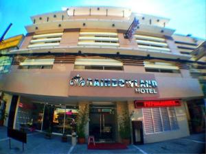 a building with a sign on the front of it at Rainbowland Hotel in Olongapo