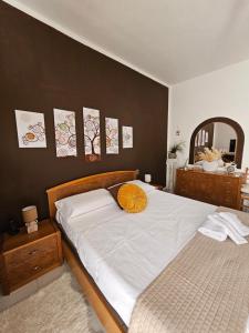 a bedroom with a bed with a yellow pillow on it at La Casa nel Paesello in Portocannone