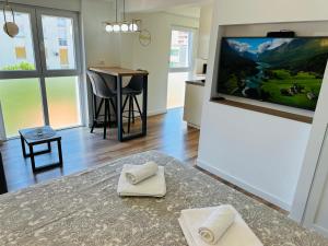 a living room with a flat screen tv and a table at Apartment Mara&Padrona in Zadar +38 photos