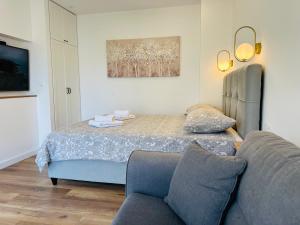 a living room with a bed and a couch at Apartment Mara&Padrona in Zadar