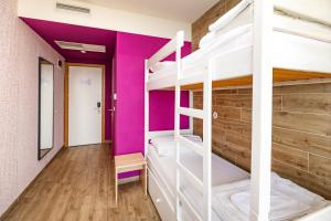 a room with bunk beds in a hostel at Hostel Link in Lovran