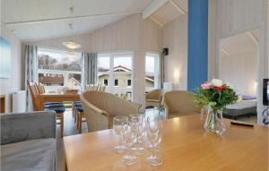 a dining room with a table with wine glasses on it at Frische Brise 18 - Dorf 3 in Priwall