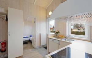 a kitchen with a sink and a large window at Frische Brise 18 - Dorf 3 in Priwall +18 photos