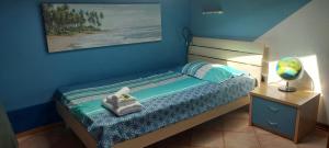 a bedroom with a bed and a desk with a lamp at Apartma Mimi in Dekani