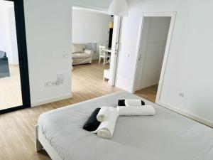 a bedroom with a bed with towels on it at Infinito in La Oliva +21 photos