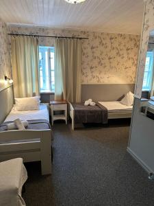 Postel nebo postele na pokoji v ubytování Vanalinna Boutique Hotel