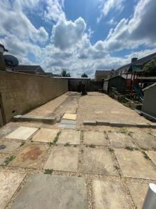an empty yard with a brick wall and a cloudy sky at 6 Bedroom House in Oxford in Oxford