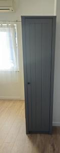 a black cabinet in a room with a wooden floor at Apartment Grubelić in Tribunj