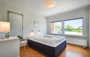 a bedroom with a bed and a large window at Three-Bedroom Holiday Home In Bredebro in Ballum