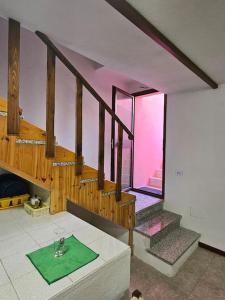 a room with a staircase with a green mat on the floor at Bel Seminterrato con finestre in Villasimius