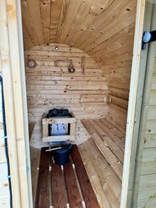an inside view of a wooden sauna with a tv at Storm Cottage in the Countryside in Parczów +42 photos