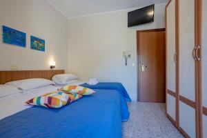 Postel nebo postele na pokoji v ubytování Hotel Stella Del Mare