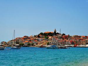 a group of boats in the water near a city at Apartment Josip in Primošten