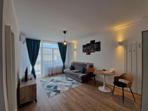 a living room with a couch and a table at Casa BID in Piteşti