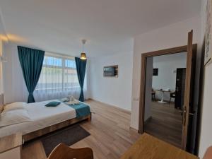 a bedroom with a bed and a sliding glass door at Casa BID in Piteşti