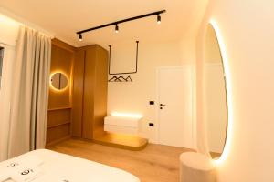 a bedroom with a mirror and a bed and a room with a bed at Lungomare ViewPoint in Vlorë +25 photos