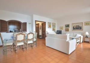 a living room with a couch and a table and chairs at Caprera Flexyrent NO air conditioning - Seafront in Santa Margherita Ligure