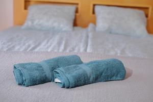 a rolled up blue towel on a bed at Apartament Słoneczny 5 in Opole