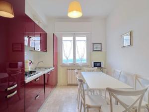 a kitchen and dining room with a table and chairs at Ampio appartamento con vista in Varazze