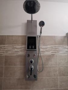 a shower with a shower head in a bathroom at Casa del barbiere in Dogliani +32 photos