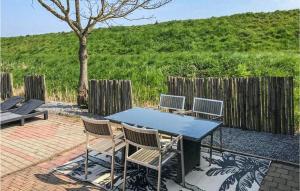 a blue table and chairs sitting on a patio at 1 Bedroom Lovely Home In Sint-Annaland in Sint Annaland