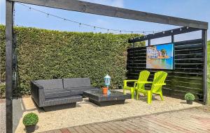 a patio with two chairs and a couch and a table at 1 Bedroom Lovely Home In Sint-Annaland in Sint Annaland