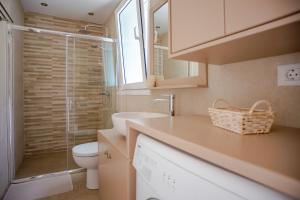 a bathroom with a toilet and a sink and a shower at Cielo e Mare Cottage in Angón +19 photos