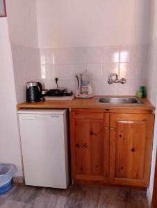a small kitchen with a sink and a counter top at Mpaliaka Myrsini in Mythimna +48 photos