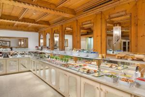 a buffet line with plates of food on display at Schlosshotel Ischgl 5-Sterne Superior in Ischgl