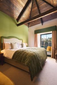 a bedroom with a large bed in a room with a window at Pier House in St Austell