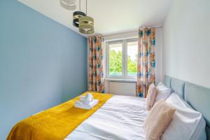 Posteľ alebo postele v izbe v ubytovaní Sienkiewicza Blue Apartment