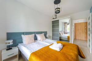 Posteľ alebo postele v izbe v ubytovaní Sienkiewicza Blue Apartment
