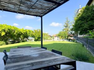 a table and chairs on a patio with a yard at ComeCasa Langhe Garden House-Pace e Panorama a Benevello in Benevello
