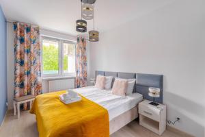 Posteľ alebo postele v izbe v ubytovaní Sienkiewicza Blue Apartment