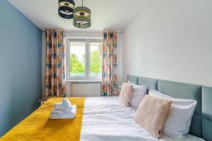 Posteľ alebo postele v izbe v ubytovaní Sienkiewicza Blue Apartment