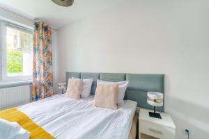 Posteľ alebo postele v izbe v ubytovaní Sienkiewicza Blue Apartment