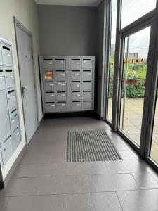 an empty room with lockers in a building with a window at Stade de France in Aubervilliers