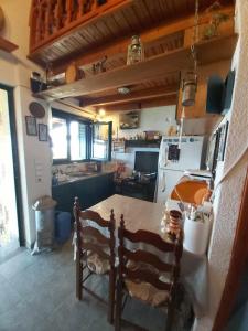 a kitchen with a table and chairs in a room at Villa Velika GR in Velika +71 photos