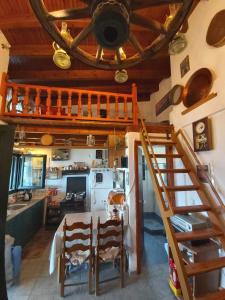 a kitchen with a table and a staircase in a room at Villa Velika GR in Velika