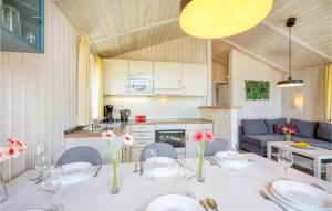 a kitchen and a dining room with a table and chairs at Freibeuterweg 20 - Dorf 5 in Travemünde