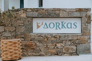a stone wall with aania sign on it at Dorkas Luxury Rooms&Apartments in Livadakia
