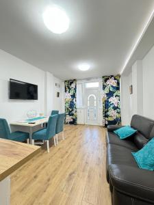 a living room with a couch and a table at Vila Kraljica 2 - apartman 7 in Vrdnik