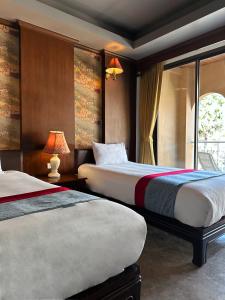 Postel nebo postele na pokoji v ubytování Grand Orlov Apart Hotel