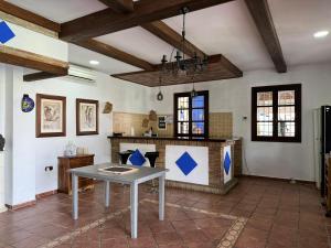 a kitchen with a table in the middle of a room at Hacienda el chorlo II in Encinarejo De Córdoba