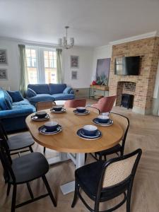 a living room with a wooden table and chairs at Victorian Villa, Hunstanton Norfolk Sleeps 20 in Hunstanton