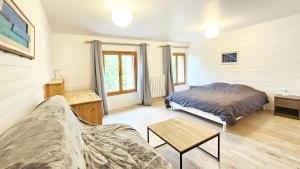 a living room with a bed and a table at La Maison de la Venise Verte - 4 chambres, jardin in Le Mazeau +17 photos