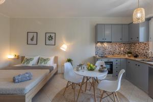 a room with a bed and a table and a kitchen at Beyond in Argostoli +20 photos