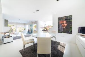 a white dining room with a table and chairs at Villa Lux in Níjar